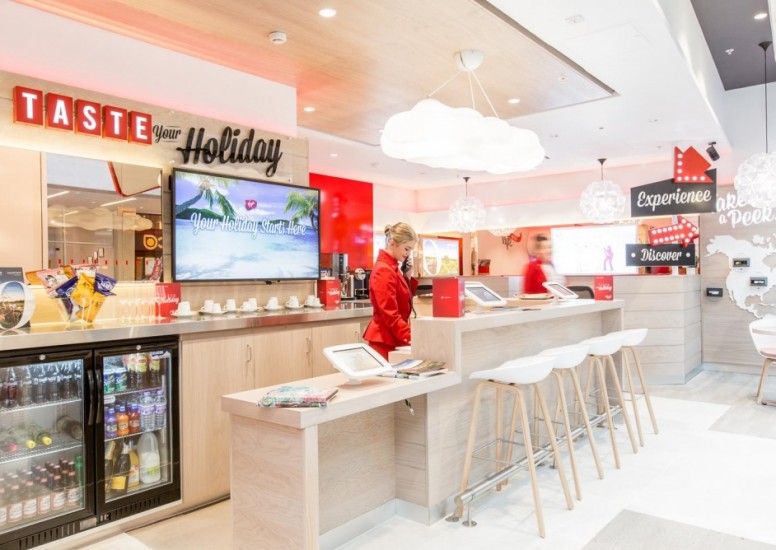 worker taking call inside virgin holiday store