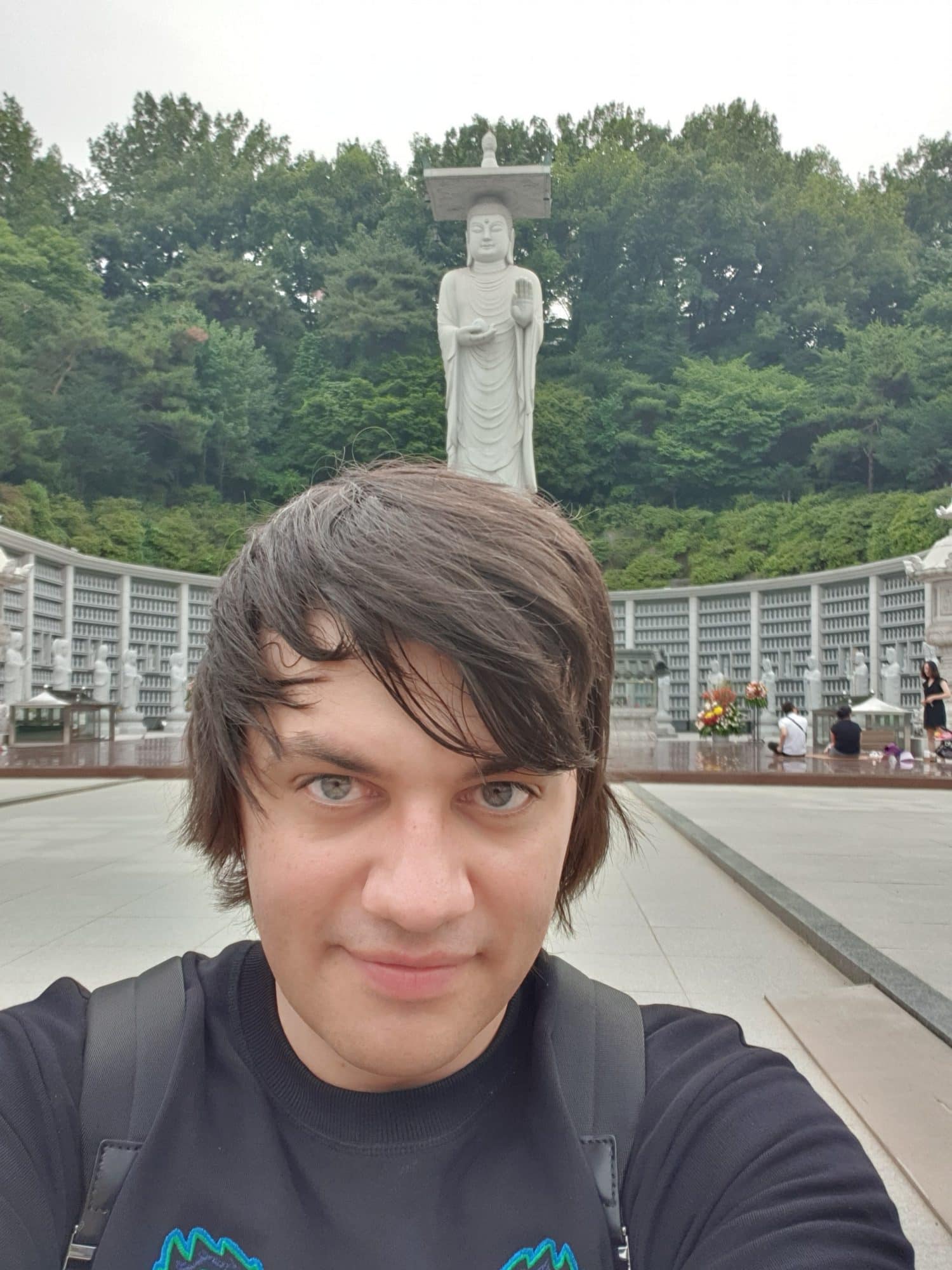 man in Seoul in front of statue