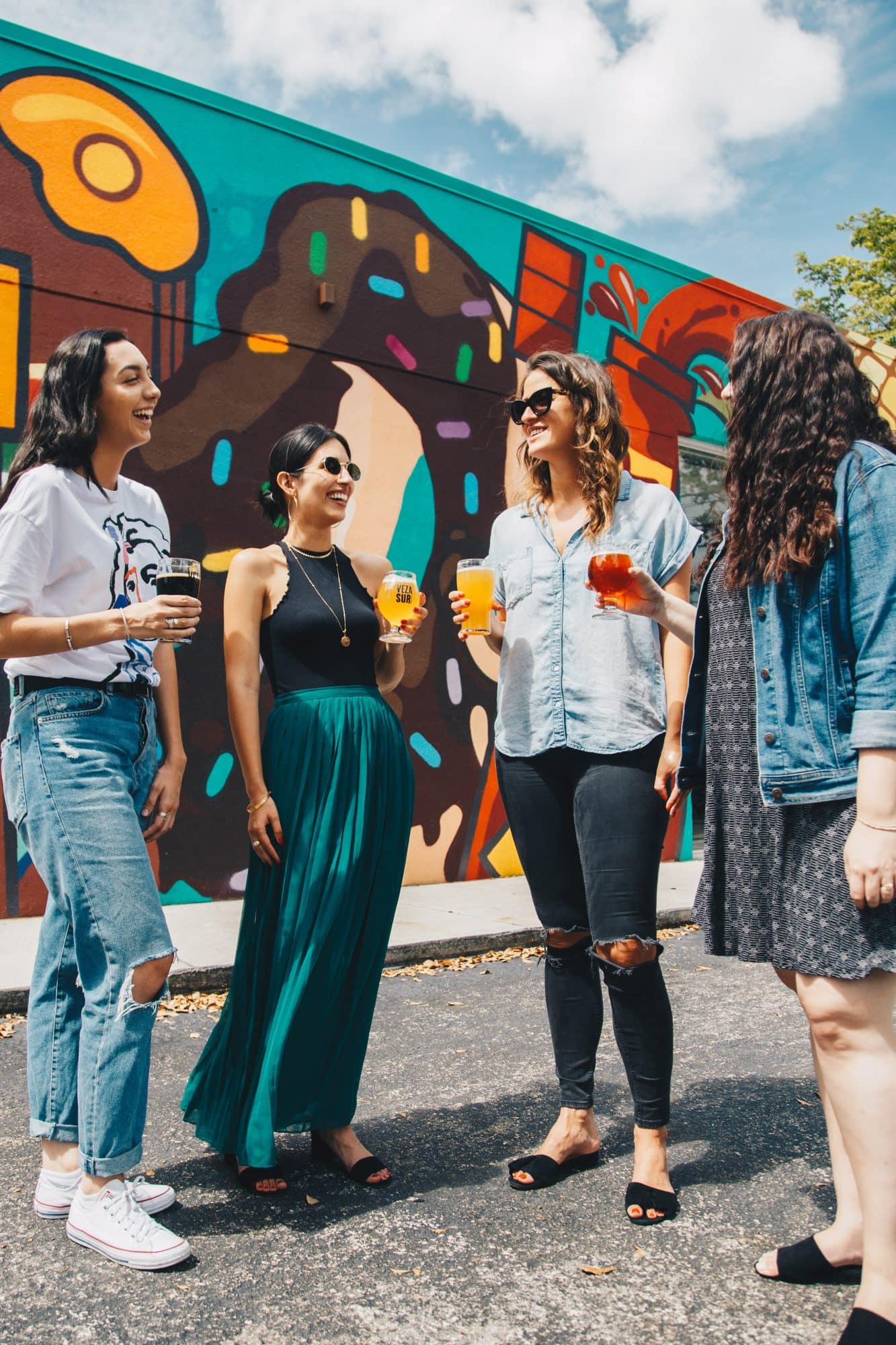 A group of girls joking and drinking
