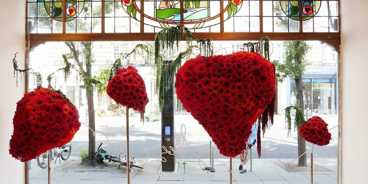 Biophilic Window Display Featuring handmade and over-sized strawberry sculptures